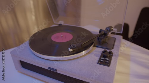 Close-up of a needle playing a vinyl record on a turntable, captured in a realistic photographic style on a fabric-textured surface background