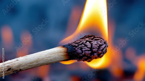 Burning matchstick on fire background.Matchstick burning with a blurred fire in the background