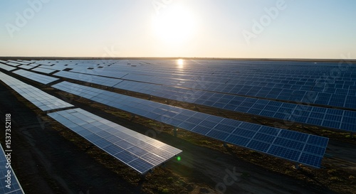 A solar panel row glinting under clear midday sun