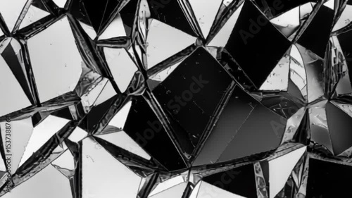 Abstract fragmented reflective surface composed of many small, irregular, mirrored triangles.