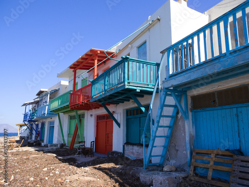 Exterior facades of colorful coastal homes in Klima village, Milos island, Greece.