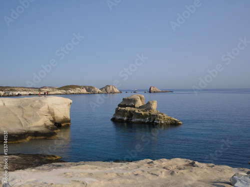 Fototapeta Naklejka Na Ścianę i Meble -  Iconic Sarakiniko beach on Milos, with white cliffs and blue water under a clear sky.