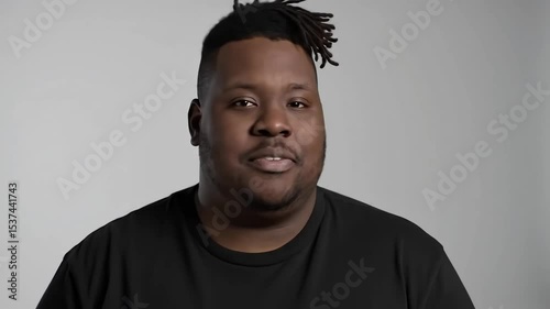 Professional Full-Figured African Man in Black T-Shirt – Gentle Studio Portrait