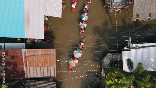 Aerial view of Damnoen Saduak Floating Market with colorful longtail boats in Thailand.