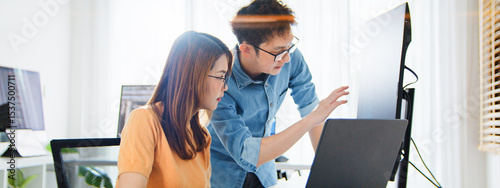 Asian male, female programming developer work together at home office, brainstorm discussion. Information technology, software engineer programmer coding job, man woman coworker teamwork. Copy space