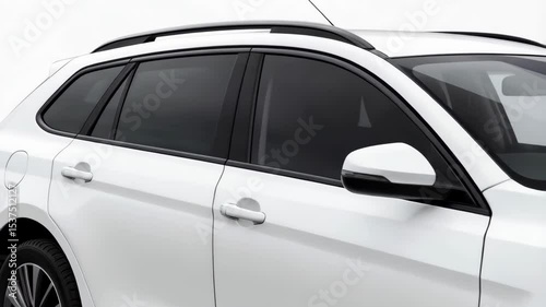 Station wagon with white exterior paint and black rims parked on a white background illuminated by studio lighting for product shot