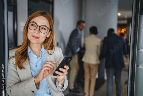 Fotografija Confident smile adult businesswoman use mobile phone on break
