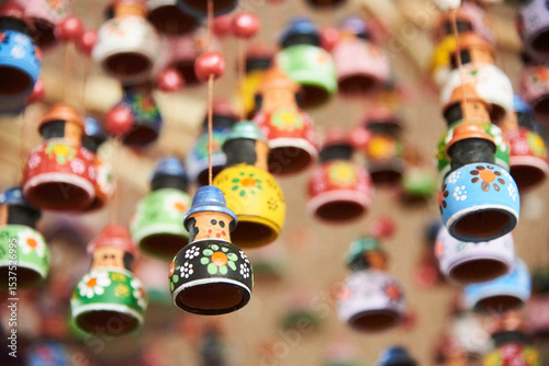 Sale of ceramic handicrafts in Raquira, Boyaca, Colombia: decorative hanging ornaments painted with colorful designs. Composition with copy space and selective focus.