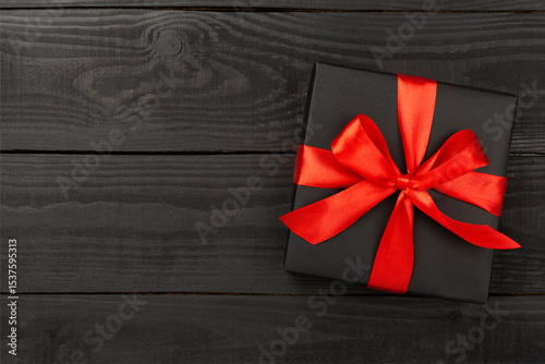Black gift boxes on wooden background, top view. Black Friday concept