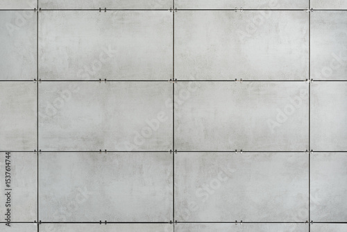фотографія The ventilated facade of grey granite tiles creates a visually appealing facade for a modern building and offices