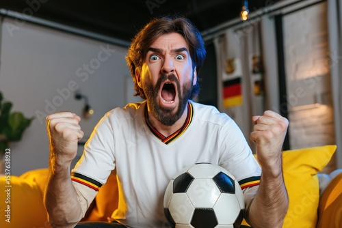 Emotional German football fan cheering passionately during a game