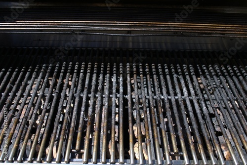 dirty grill bars with charred debris