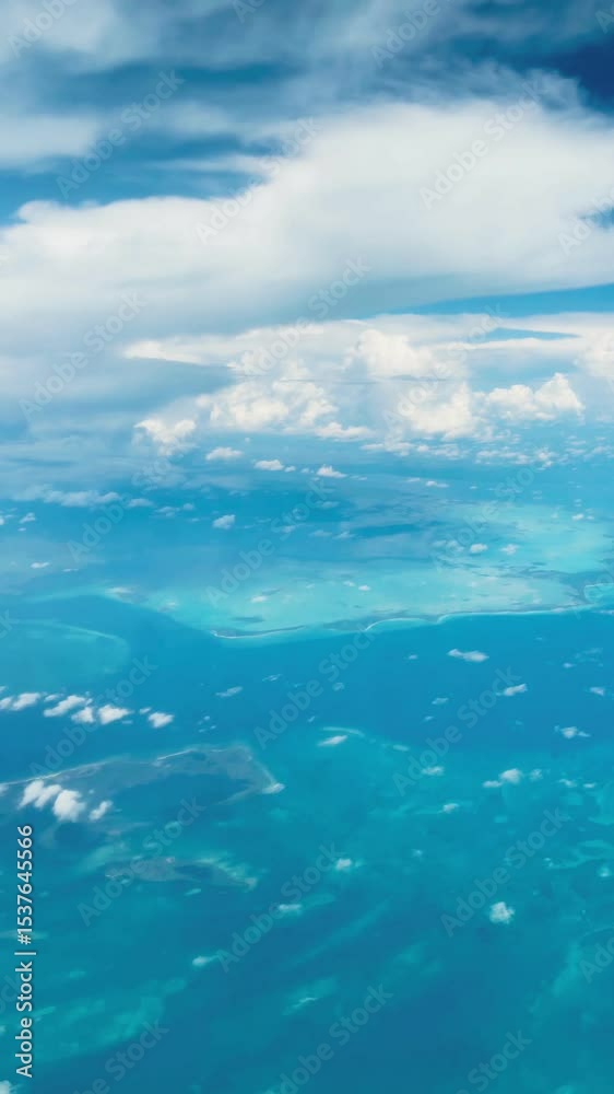 Airplane view of Cuban islands, Caribbean Sea and deep blue sky with white clouds Airplane view of Cuban islands, Caribbean Sea and deep blue sky with white clouds