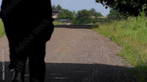 Wallpaper Mural Young man in a black tracksuit running along an empty road outdoors, showcasing fitness, urban running, and healthy active lifestyle in a natural or city environment.

 Torontodigital.ca