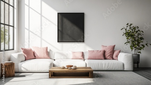 Bright, airy living room with white couch, wooden table, black framed art, and soft light