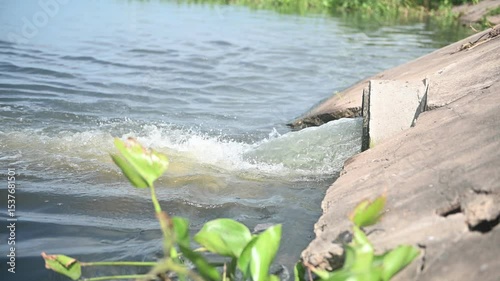 Wastewater from industrial plants flowing from drains into rivers