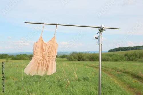 Elegant summer dress hanging outdoors on a clothesline