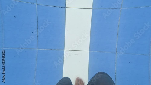 Single man do aqua running in the swimming pool with blue and white ceramic