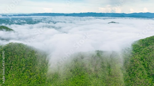 Hyperlapse video in 4k motion. Beautiful aerial view of a sea of fog in the morning forest on a mountain and road with green mountains. Nong Ya Plong, Phetchaburi, Thailand.