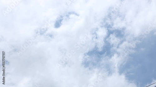 Time lapse of white and dark clouds moving against blue sky before rain. Summer nature weather sky. 4K video. 