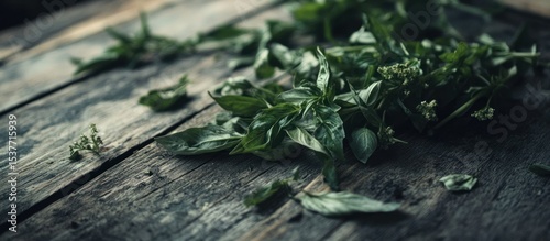 Fresh basil leaves gracefully arranged on rustic wood, evoking natural simplicity