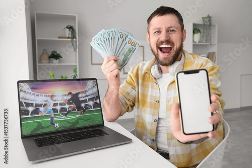 Happy young man with mobile...