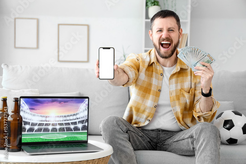Happy young man with mobile...