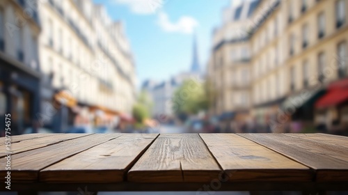Empty wooden table with blurred Parisian street background.