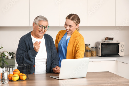 Young caregiver with senior...