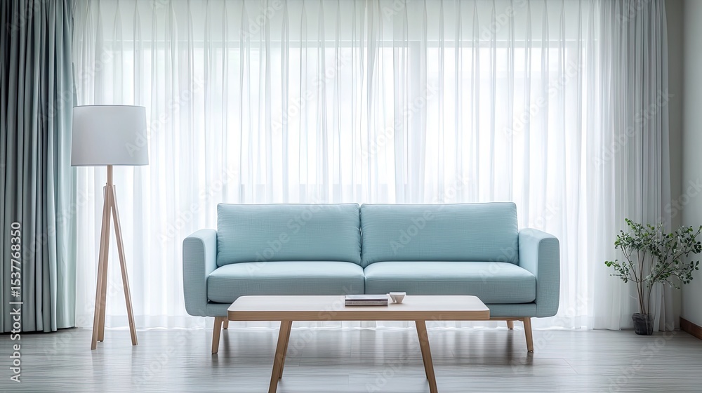 Fototapeta premium Light-filled living room with a light blue sofa and wooden furniture.
