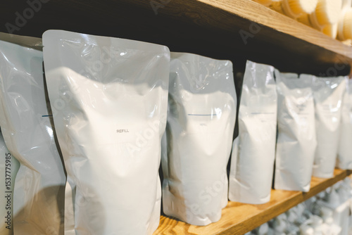 Choosing Refill packet. Zero waste. Reuse reduce recycle concept. refill liquid soap, shampoo and other products. Plastic packaging for refill pouch isolated on white background.