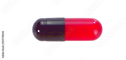 One black and red capsule pills isolated on white background.