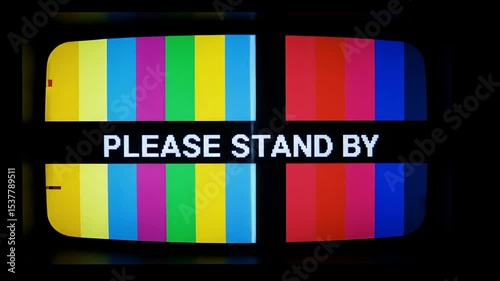 A vintage television screen displaying a colorful test pattern with 