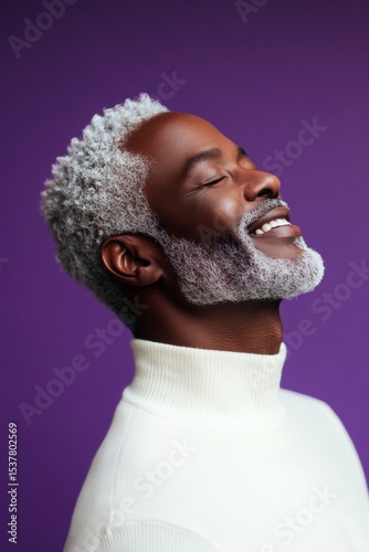 A handsome man in his 40s with a radiant smile. An artistic and modern man captured in a studio. A stylish and glowing male with a relaxed aura. A peaceful and radiant male in a confident pose.