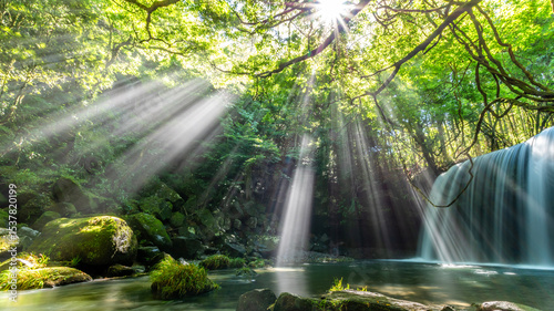 Sunbeams Shine Through Forest onto Nabegataki Waterfall in Kumamoto, Japan