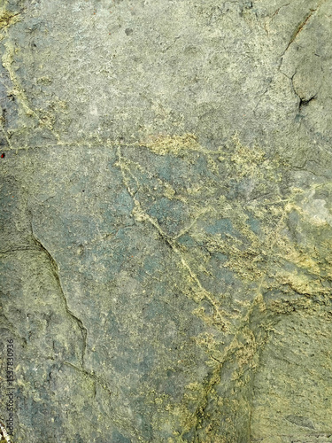 Textured stone background with rough rock wall surface, abstract natural grunge detail of stone material
