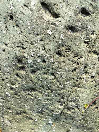 Textured stone background with rough rock wall surface, abstract natural grunge detail of stone material