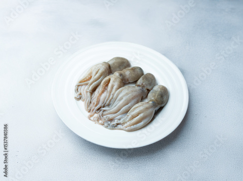 Photos raw short arm octopus on a plate
