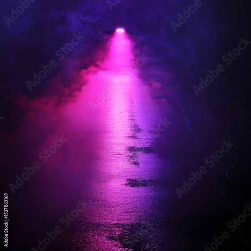 Pink light beam across water at night, creating purple reflections