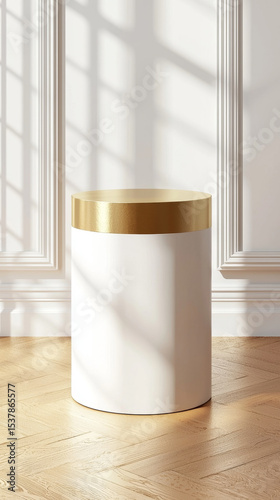 Gold-topped white cylinder on light wood floor, sunlit