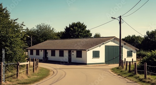 Farm Building With Green Shutters and Garage Doors in Rural Setting