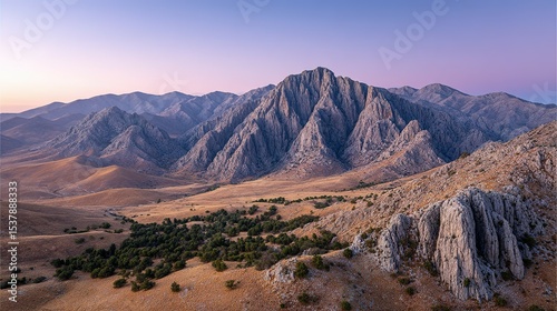 A vast mountain landscape stretches across the arid valley.