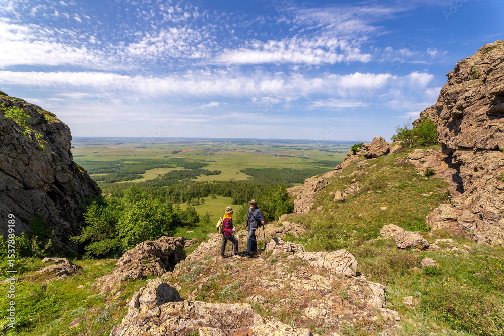 Fototapeta premium tourists men and women walk along the ridges of the Southern Urals on a summer day. Irendyk ridge