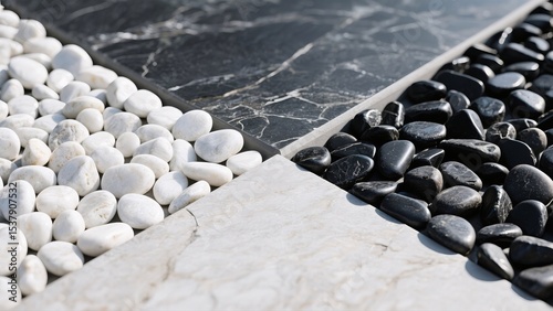 Close-up view of decorative stones and marble tiles in black and white patterns, creating a sophisticated texture effect. The contrast between the materials adds visual interest and versatility.