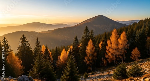Tranquil Mountain Vista with Autumnal Hues and Atmospheric Golden Light