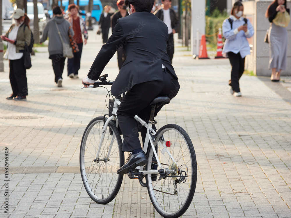 Fototapeta premium 日本の都市の街の通行人と自転車を乗るサラリーマンの姿