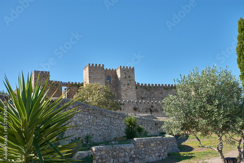 Trujillo Castle in Extremadura with its 9th-century defensive architecture surrounded by nature under an intensely blue sky