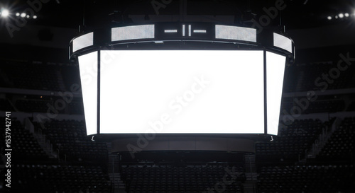 Large blank scoreboard in empty sports arena with dark surroundings  