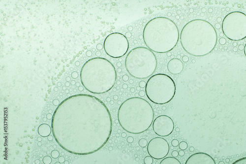 Macro microscope green bubble texture, Close-up Green bubbles and drops oil background . blue green water bubbles, close up golden oil drop for cosmetic