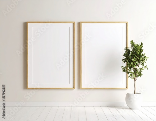 Minimalist interior with two blank frames and potted plant on white wood floor
